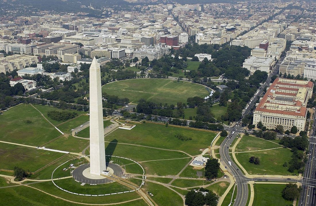 Aerial view of the Washington Monument with the White House beyond